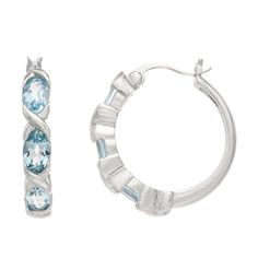 Genuine blue topaz decorates these silver-tone hoop earrings, making them an elegant accessory. Genuine blue topaz decorates these silver-tone hoop earrings, making them an elegant accessory. Length: 22 mm Backings: click-it Nickel free Packaging: boxed STONE DETAILS Stone type: blue topaz Cut: oval Stone size: 6 mm x 4 mm Gender: female. Age Group: adult. Material: Sterling Silver. Sterling Silver Birthstone Hoop Earrings, Silver Hoop Earrings With Gemstones In Fine Jewelry Style, Silver Gemstone Hoop Earrings Fine Jewelry, White Gold Hoop Earrings With Gemstones, Silver Gemstone Hoop Earrings, Silver Hoop Earrings With Gemstone, Silver Small Hoop Earrings With Gemstone, Earrings Making, Oval Stone