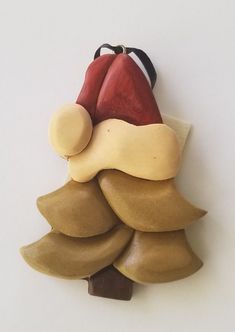 a ceramic christmas tree ornament hanging on a wall