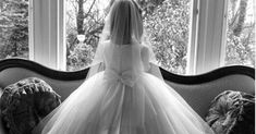 a woman in a wedding dress sitting on a couch