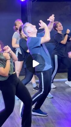 a group of people dancing on a wooden floor