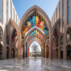 an archway with stained glass windows in the middle of a large room filled with columns and arches