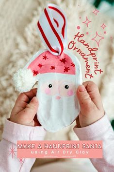 a child holding up a santa clause ornament to show it's face