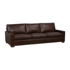 a brown leather couch sitting on top of a white floor