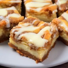 several pieces of dessert on a plate with icing and cinnamon rolls in the middle