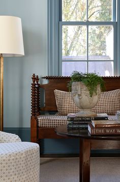 a living room with a couch, chair and table in front of a large window