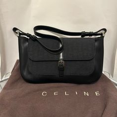 Brand New Vintage Celine Shoulder Bag With Tag Designer Black Baguette Bag For Travel, Designer Black Baguette Bag With Removable Pouch, Designer Black Baguette Shoulder Bag, Elegant Coated Canvas Shoulder Bag For Business, Black Designer Satchel Baguette Bag, Rectangular Evening Bags With Leather Trim, Classic Office Shoulder Bag With Leather Trim, Black Shoulder Bag For Office With Dust Bag, Modern Coated Canvas Shoulder Bag For Office