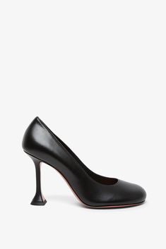 Black leather pumps from Amina Muaddi. The Iris pumps are made of black leather, with rounded tips and sit on a mini coctail stiletto heel measuring 95 mm.Measurements: L30 x H13 x W9 cmMade in Italy