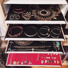 a collection of jewelry sitting on top of a drawer