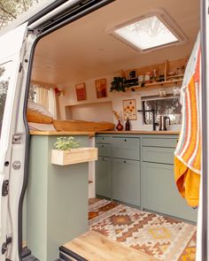 an open van door showing the kitchen and dining area