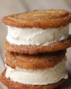 three desserts stacked on top of each other with whipped cream and cinnamon sprinkles