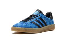 The Gucci x adidas Gazelle “Blue” is a limited edition collaboration between the legacy fashion brand and adidas on the retro shoe with Gucci’s iconic monogram print on its design.  Marking the second-ever collaboration between Gucci and adidas, the Gazelle in “Blue” updates the old school shoe with Gucci’s famous “GG” monogram patterning in an all-over style that draws favorably from 1980s-era sportswear.  Black leather Three Stripes branding can be found on either side of the shoe while gold co-branding appears on the black leather heel tab.  More co-branding is located on the tongue.  “GG” embossed branding is found along the gum rubber midsole.  Release date: March 31, 2023 Adidas Shoes Gazelle, Adidas Gazelle Blue, Adidas X Gucci, Gucci X Adidas, Stripes Branding, Blue Core, School Shoe, Gucci Brand, Gg Monogram