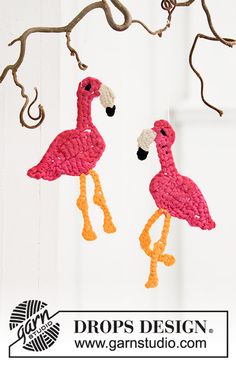 two pink flamingos hanging from a tree branch with the words drops design on it