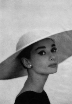 black and white photograph of a woman wearing a large hat