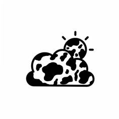 a black and white cow laying on top of a pile of hay with the sun behind it