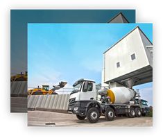 a truck is parked in front of a building with construction equipment on the other side