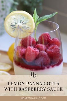 lemon panna cota with raspberry sauce in a glass on a table