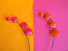 two different colored paper with flowers in them on the left and right sides, one pink and one orange