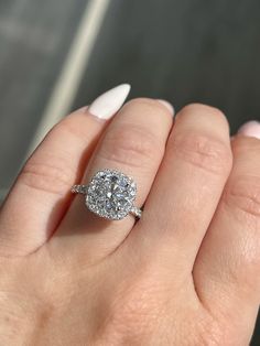 a woman's hand with a diamond ring on it