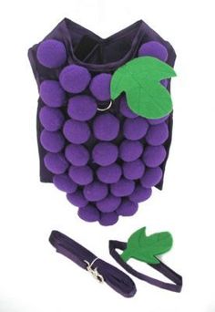 a bunch of grapes sitting on top of a table next to a pair of scissors