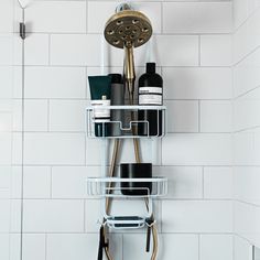 there is a shower head and two shelves in the bathroom