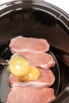 the meat is being prepared in the slow cooker with a yellow sauce on it