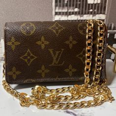 Authentic Louis Vuitton Monogram Wallet In Good Preowned Condition With Some Signs Of Wear Including Peeling And Fading. Spacious Enough For Your Cards, Bills, Coins And Some Small Accessories. Date Code Sp1015 All Items Are 100% Authentic Or Your Money Back Guarantee. Comes With Removable Custom Non Brand Gold Chain And Hardware Attached For Versatile Carry Such As Shoulder Bag, Waist Bag Or Crossbody. Box Not Included. Please See All Pics And Ask Any Questions That You May Have Prior To Purchasing. Make Sure Your Payment And Address Is Correct To Avoid Returns Or Cancellation. Tags To Ignore: Alice + Olivia Vintage Vt Chic Nd Lovers + Friends Suit Pink Blue Yellow Orange Colorful Pattern Luxury Monogram Canvas Bag With Card Slots, Brown Monogram Canvas Bag With Card Slots, Designer Gold Wallet With Chain Strap, Lv Wallet On Chain Ivy, Brown Rectangular Wallet On Chain With Gold-tone Hardware, Louis Vuitton Phone Case Wallet, Fran Fine, Louis Vuttion Key Pouch, Louis Vuitton Men’s Wallet