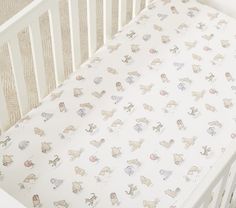 a white crib with animals on it