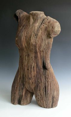 a wooden sculpture sitting on top of a white table