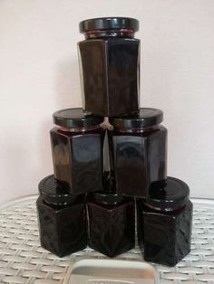 a stack of black containers sitting on top of a white table