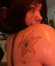 a woman with a flower tattoo on her back