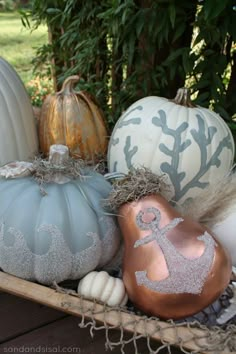 pumpkins and gourds are sitting in a basket