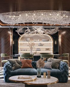 a living room filled with lots of furniture and a chandelier hanging from the ceiling