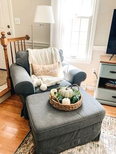 a living room filled with furniture and a flat screen tv on top of a hard wood floor