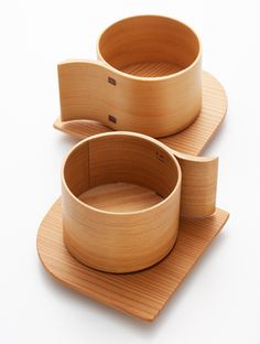 three wooden bowls and plates sitting on top of each other