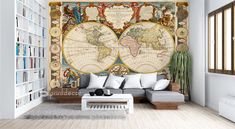 a living room filled with furniture and a large map on the wall in front of it