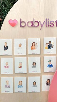 there are many pictures on the wall in front of this baby's name sign