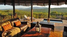 an outdoor living area with couches and tables