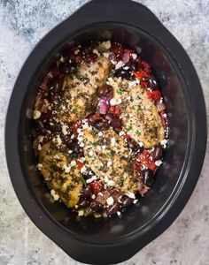 an overhead view of a crock pot filled with meat and vegetables