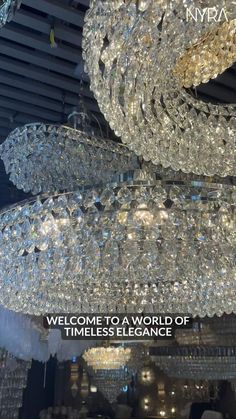 a large chandelier hanging from the ceiling in a store with words welcome to a world