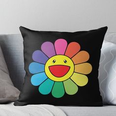 a colorful flower with a smiley face on black background throw pillow by designbybe