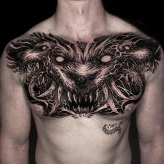 a man with tattoos on his chest is looking at the camera