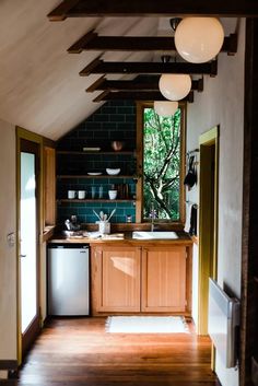 an open kitchen with wooden floors and cabinets