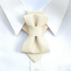 "This unisex accessory is a modern combination of elements found on traditional ties and bow ties. It is recommended not to tighten the regulation strip too much: Hopper tie is at its best when leveled up with the collar line. Freestyle fashion lovers should bear in mind that this accessory also looks great with the collar unbuttoned. This unique product registered as „one of a kind\". Designed in Lithuania and awarded the gold medal for its charm. Each item is packaged in a gorgeous box includi Luxury White Ties For Formal Occasions, White Bow Tie For Wedding, Elegant Beige Tie For Black Tie Events, Elegant White Tie For Groom, Elegant Cream Standard Tie, Dapper White Bow Tie For Wedding, White Dapper Bow Tie For Wedding, White Bow Tie Back Ties For Wedding, Elegant White Bow Tie For Black Tie Occasions