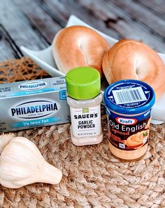 an assortment of food items sitting on top of a straw hat next to a bagel