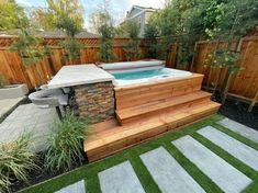 an outdoor hot tub in the middle of a yard