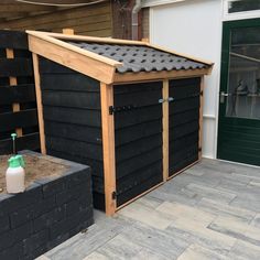 a black shed with a green water bottle in it