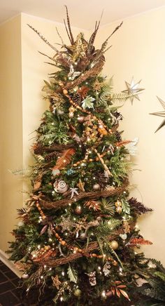 a decorated christmas tree in the corner of a room