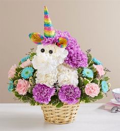 a basket filled with flowers and a unicorn face