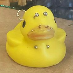 a yellow rubber ducky sitting on top of a floor