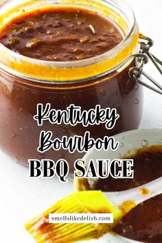 kentucky bourbon bbq sauce in a glass jar with a spoon next to it and the words kentucky bourbon bbq sauce